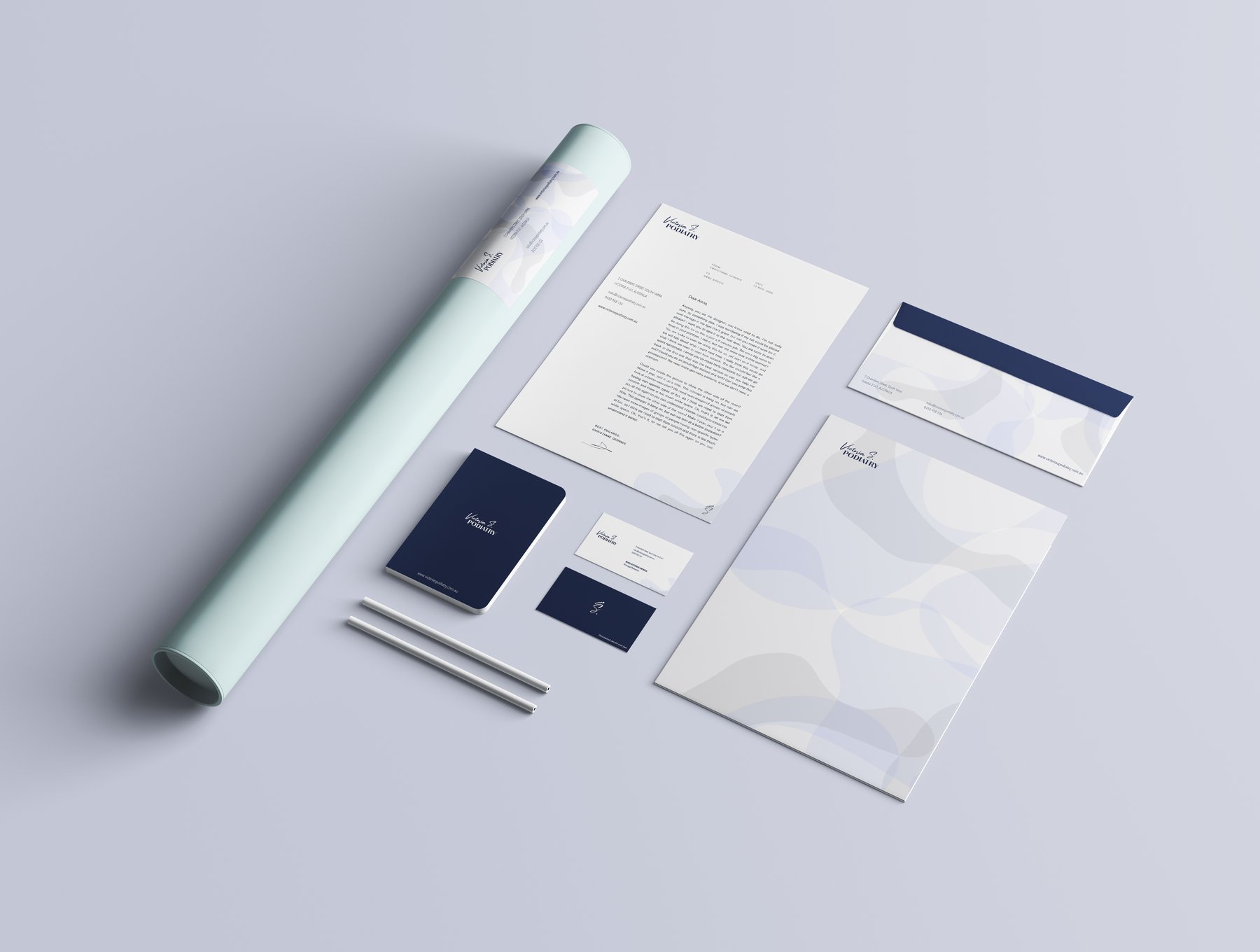 Victoria S Podiatry stationery system — letterhead, business cards, envelopes, notebooks, appointment cards, signage tubes